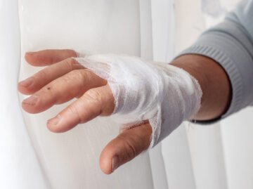 Man's bandaged hand, injured hand, first aid