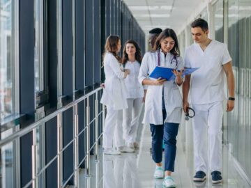 team-young-specialist-doctors-standing-corridor-hospital
